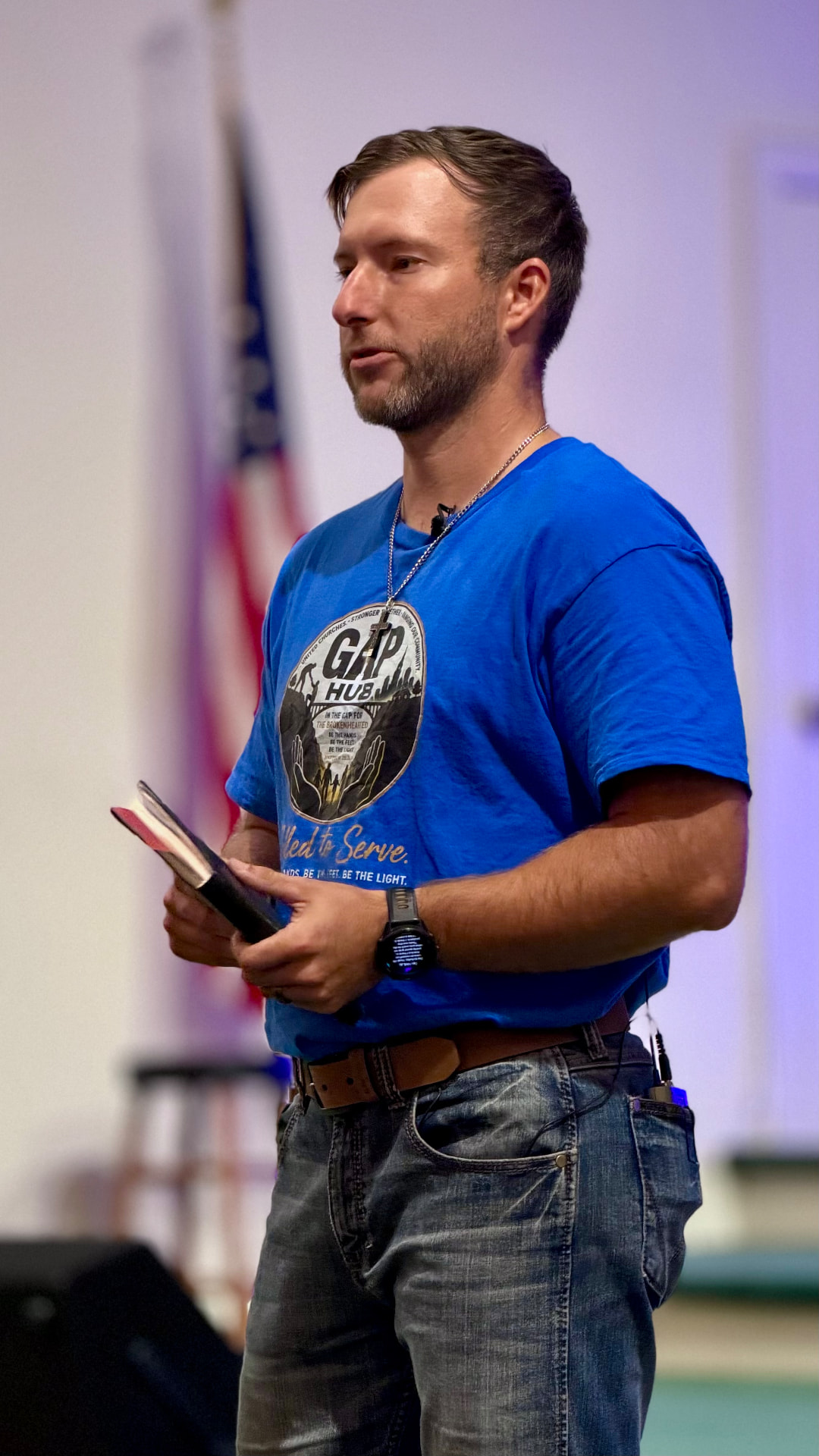 Seth Brooks speaking, holding his Bible